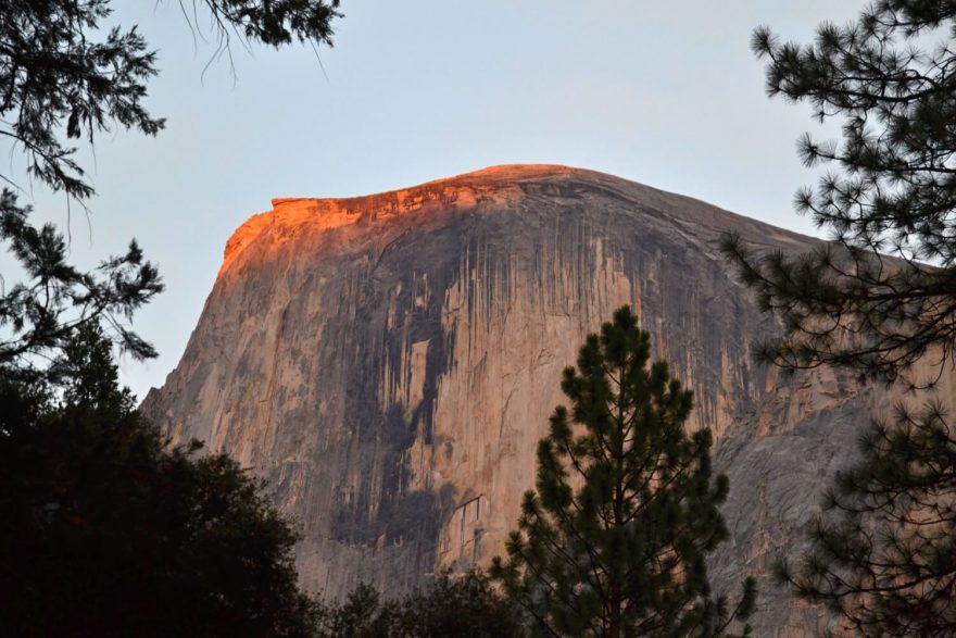 Západ slunce zbarvuje vrchol Half Dome, Yosemite Valley, Kalifornie, USA