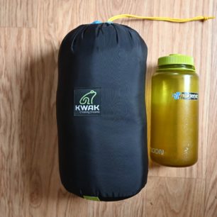 Zabalený spacák TOPQUILT ANURA A185 v porovnání s lahví Nalgen 1 litr