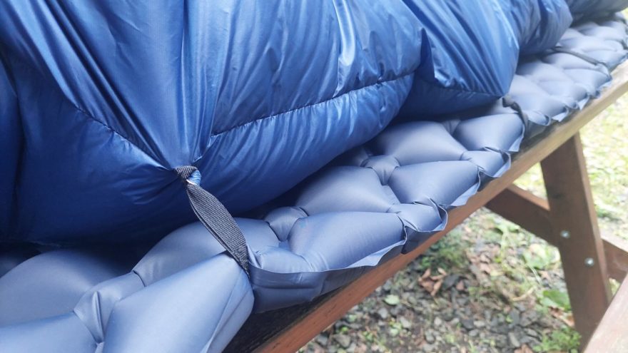 Fixace spacáku SIR JOSEPH TETON 560 QUILT ke karimatce pomocí trojice elastických popruhů