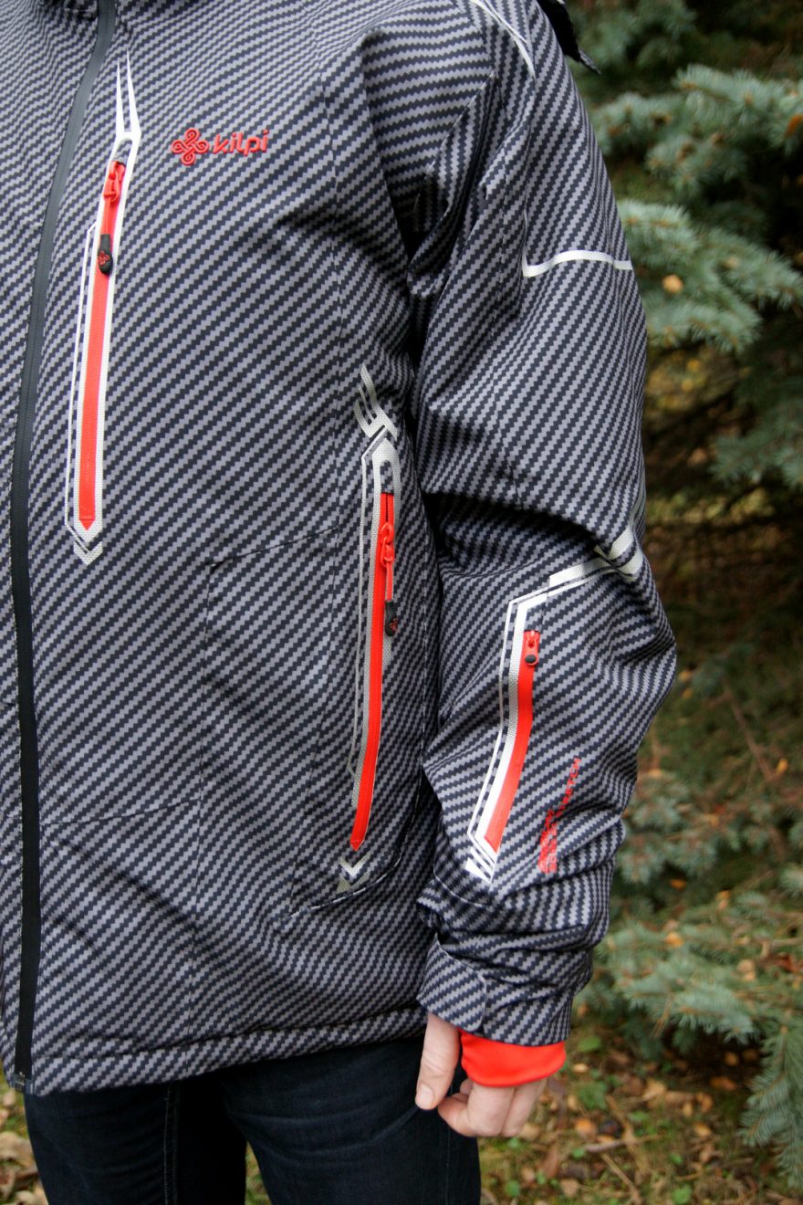 Kapsy mají nepromokavé zipy a barevně kontrastují se zbytkem bundy