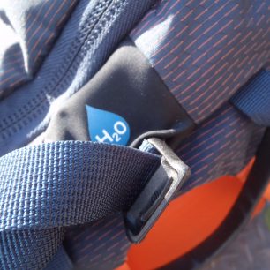 Vytažený fixační popruh H2O otvorem.